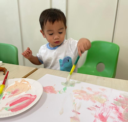 Mateo doing blots of paint on paper!