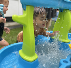 Mateo enjoying some water play during mud kitchen day!