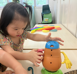 Maya having fun with Mr Potato.