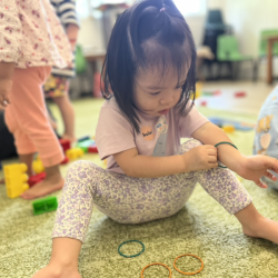 Maya putting on bangles around her wrist.