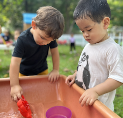 Romy and Wesley pouring water in the trough!