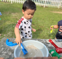 Wesley loves playing with sand!