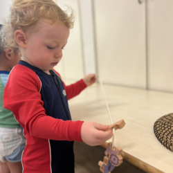 Arthur threading large beads!