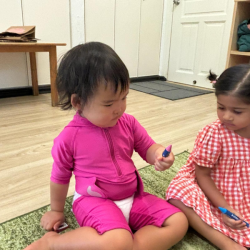 Cara picking a crayon according to the song’s question - what’s your favourite colour?