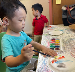 Daniel painting his hot air balloon craft with water colours!