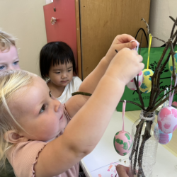 Eleanor helping to hang some eggs!