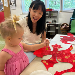 Eleanor painting a dragon with spots!