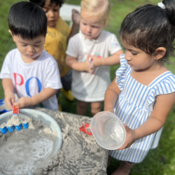 Kai and Wesley engaging in sand kitchen play!