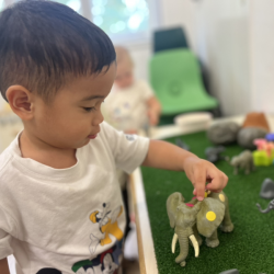 Mateo delighting in play with Elmer’s Small World!
