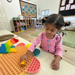 Nysha loves manipulating with the giant pop it.