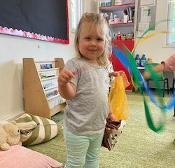 Olivia dancing with ribbon sticks with music!