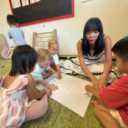 Pasting cotton balls to make some clouds for our bulletin board!