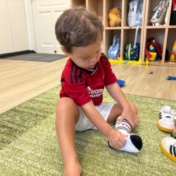 Rowan attempting to remove his socks all on his own! .