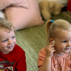 Arthur and Eleanor listening to sounds of the ocean from the shells!