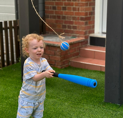 Arthur taking great delight in the ‘whack a ball’ game!