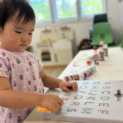 Cara doing some letter tracing on magnetic pads!