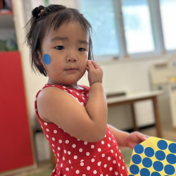 Celene having fun peeling and pasting dot stickers!