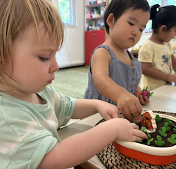 Edwina and Cara working on their fine motor muscles pulling manipulatives!