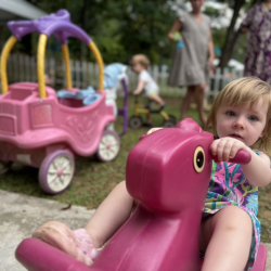 Edwina having fun on the rocking horse!