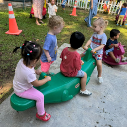 Eleanor, Wesley and Celene having fun on the see saw!