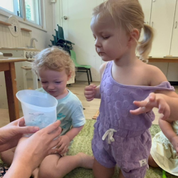 Eleanor dropping her coloured eel in warm water to watch the colour change!