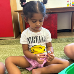 Nysha engaging in the alphabet soup activity!