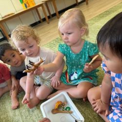 The Sunbirds children playing an alphabet soup phonics game.