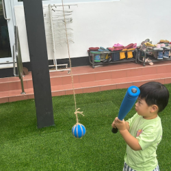 Wesley attempting to strike the ball with a bat!