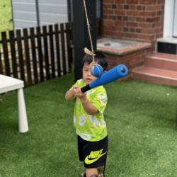 Wesley having a go at hitting the ball!