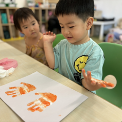 Wesley loving his clown fish handprint craft!